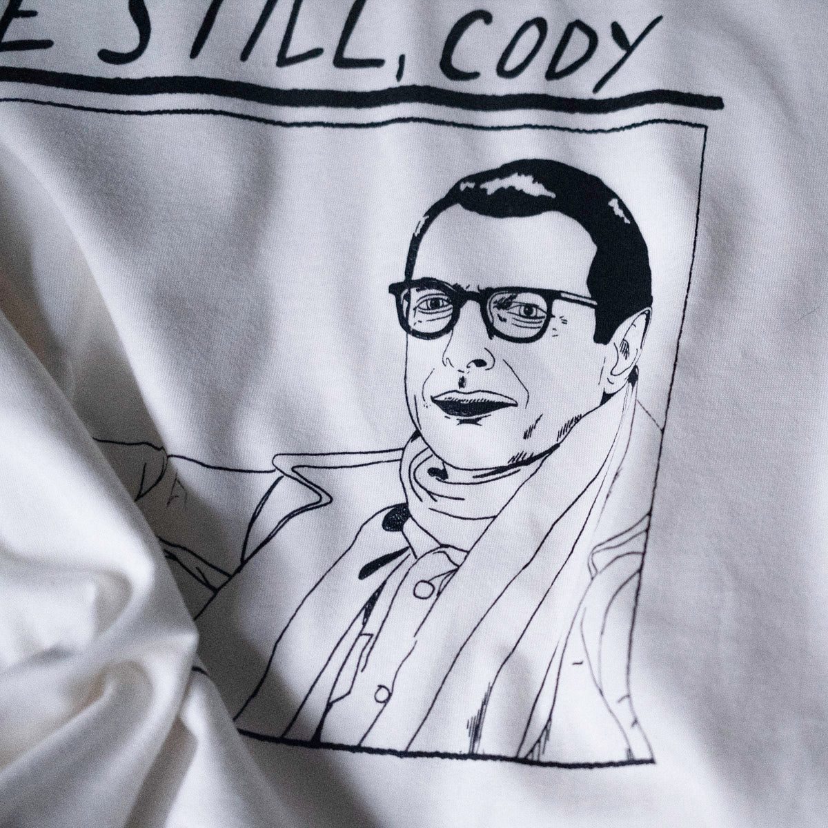 close up of drawing of jeff goldblum's face in the life aquatic by wes anderson. illustrated and screen printed on a white t shirt